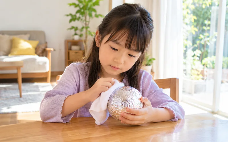 アルミホイルのピカピカ玉で遊ぶ子ども